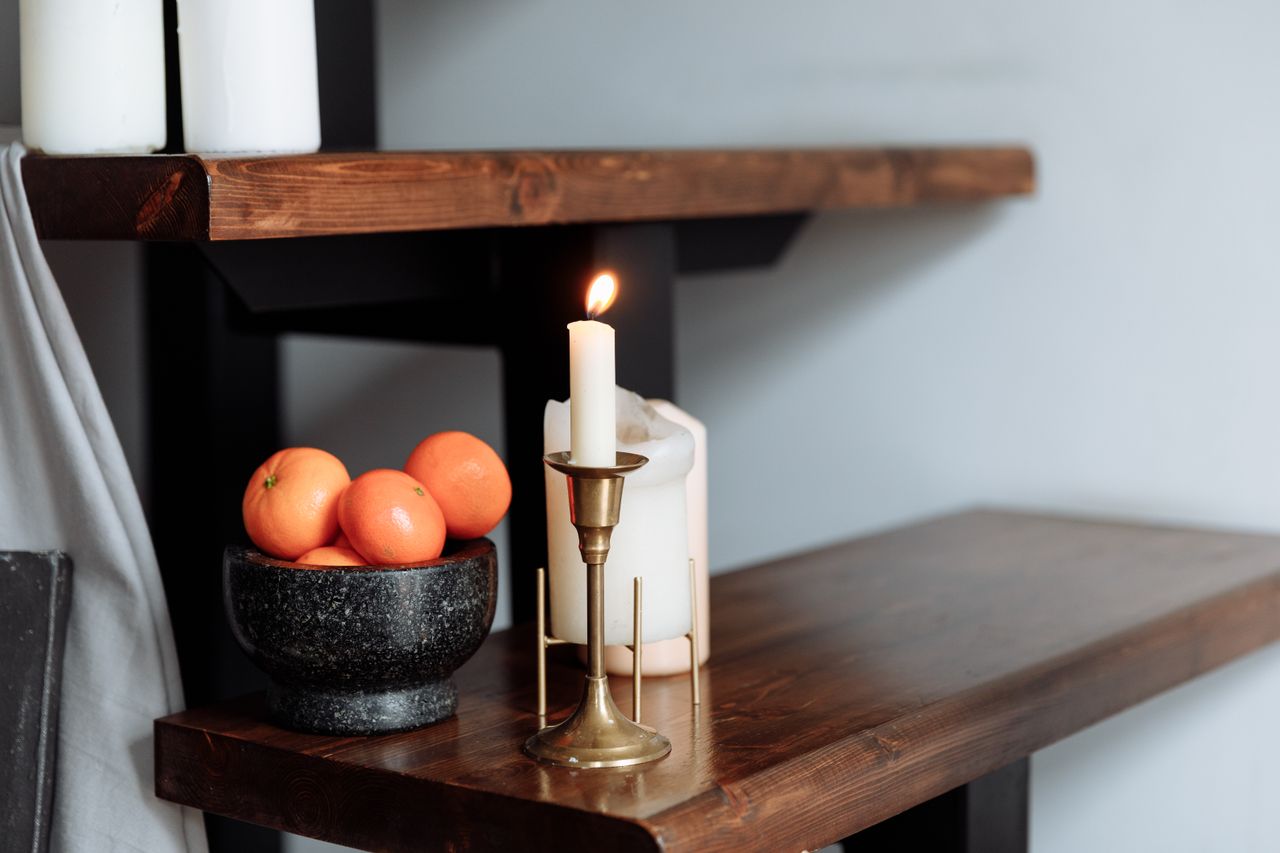 Lit candles glowing in a warm minimal room